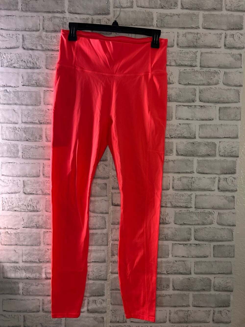 Fabletics High-Waisted Pocket Leggings in Neon Coral